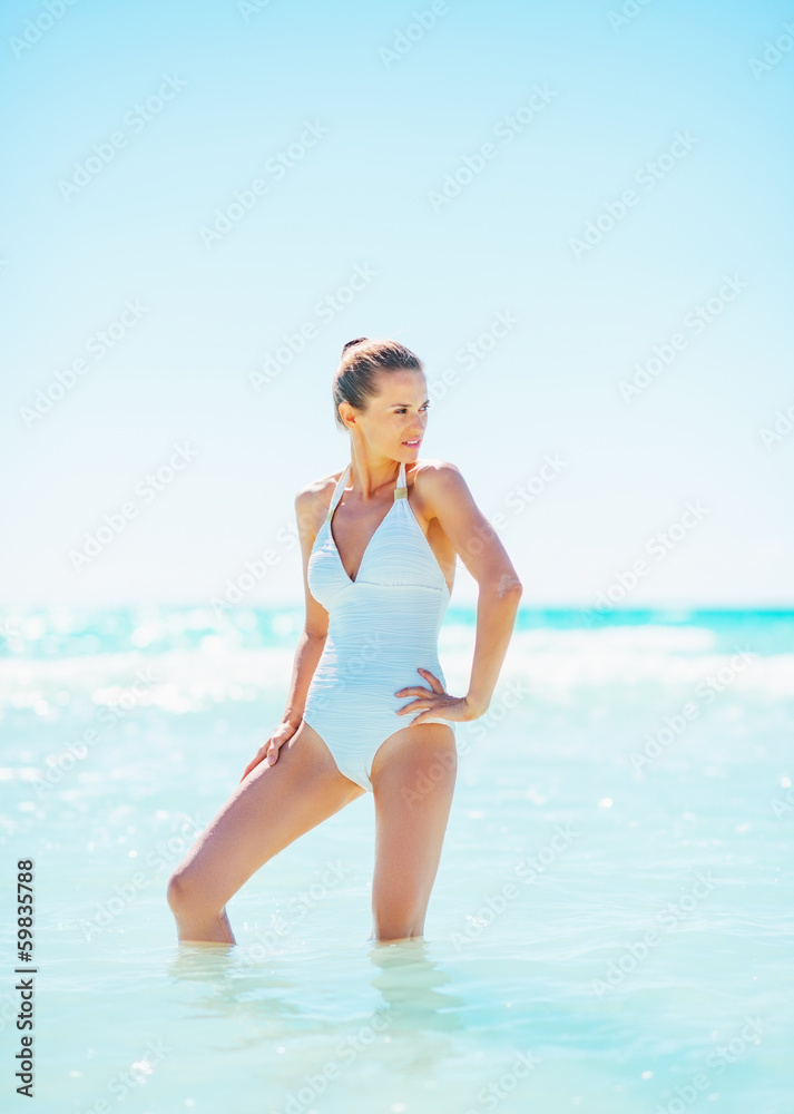 Full length portrait of young woman standing in sea Full length portrait of young woman standing in sea