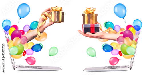 hand with a gift and laptop