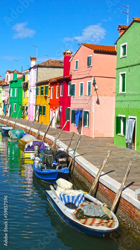 channel with boats on the island of Burano, Venice, Italy