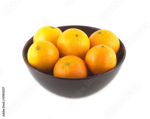 Orange tangerines inside purple china bowl isolated closeup