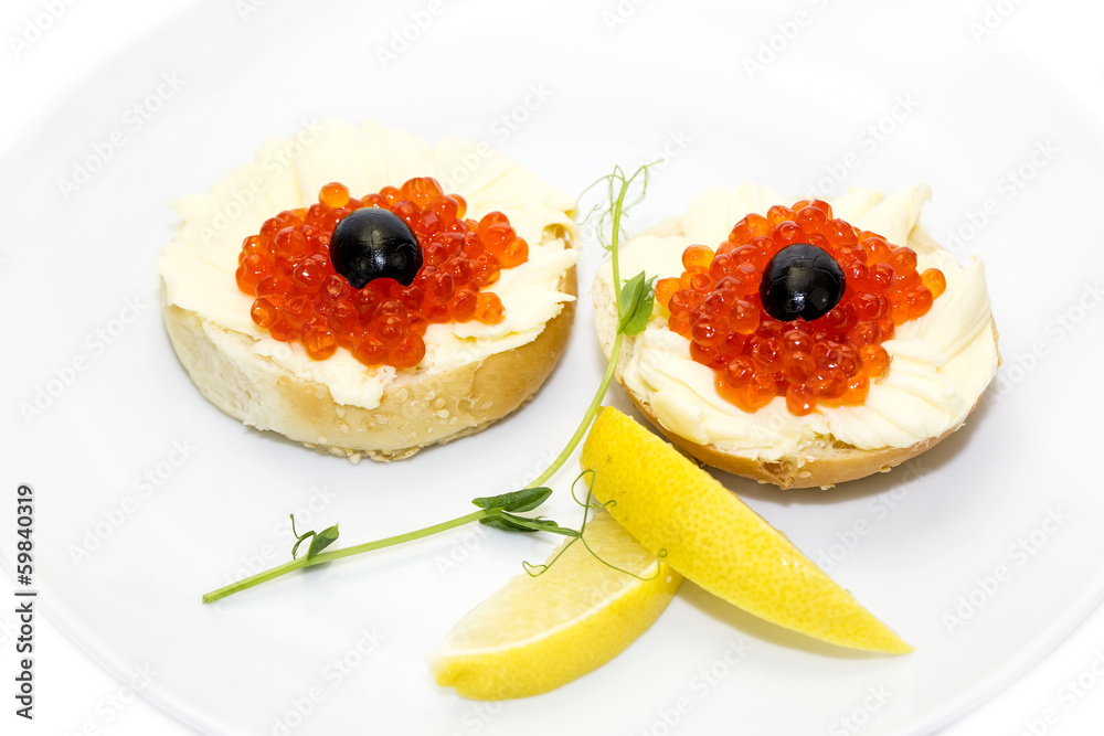 canape with red caviar and lemon on white background canape with red caviar and lemon on white background