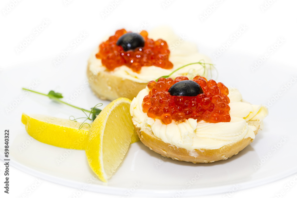 canape with red caviar and lemon on white background canape with red caviar and lemon on white background