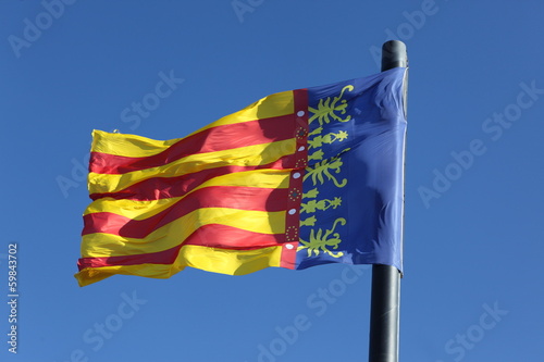 Flag of Comunidad Valenciana, region in Spain, moving in the win photo