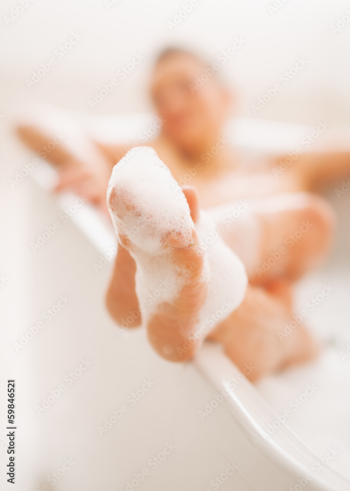 Fototapeta premium Closeup on legs of young woman in bathtub