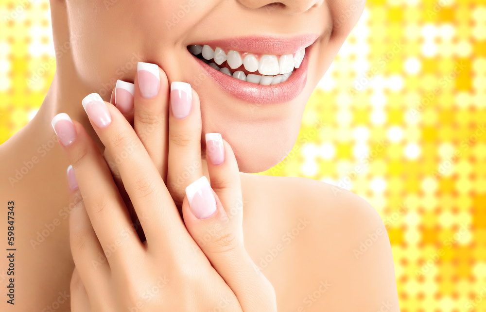 Face, hands and healthy white teeth of a woman Face, hands and healthy white teeth of a woman
