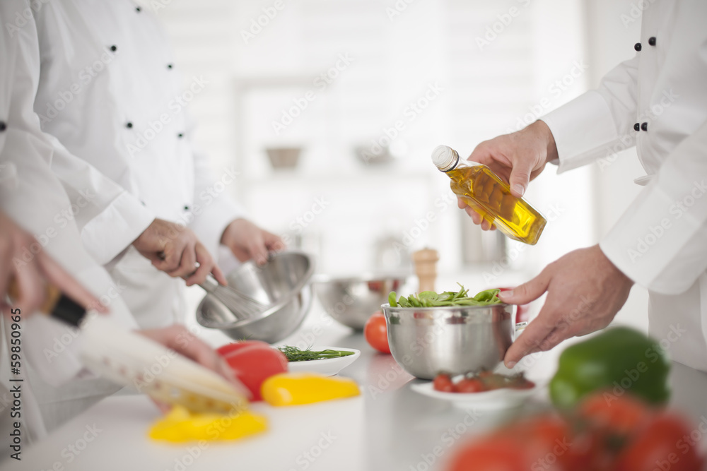 anonymous hands preparing food in professional kitchen anonymous hands preparing food in professional kitchen