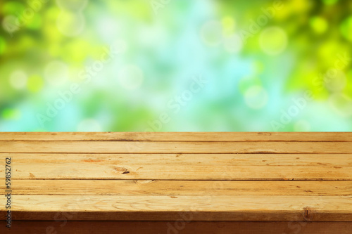 Fototapeta Naklejka Na Ścianę i Meble -  Empty wooden deck table over garden bokeh background