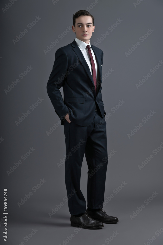 Retro fashion fifties young man wearing dark suit and tie. Studi Retro fashion fifties young man wearing dark suit and tie. Studi