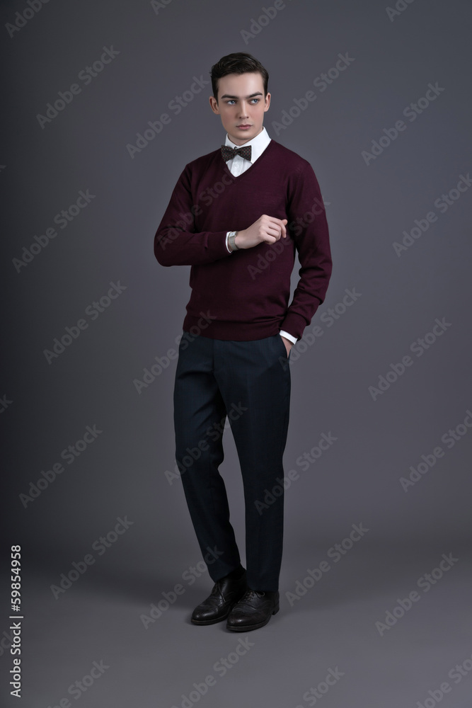 Retro fifties english style fashion man looking at his watch. We Retro fifties english style fashion man looking at his watch. We