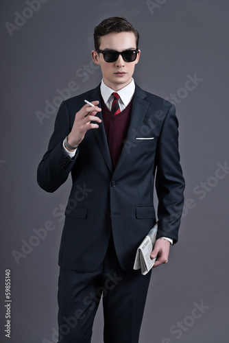 Retro fifties fashion young businessman with black sunglasses we