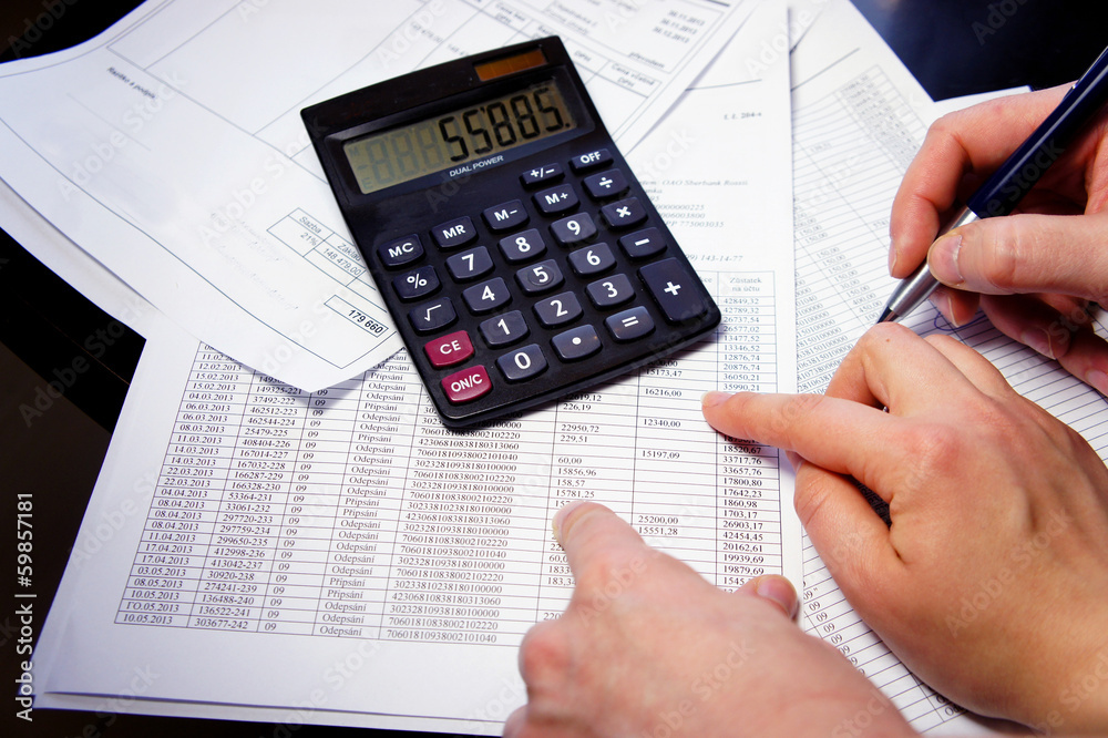 Office table with calculator, pen and accounting document Office table with calculator, pen and accounting document