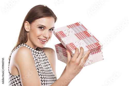 beautiful smiling girl opening a gift box on a white background