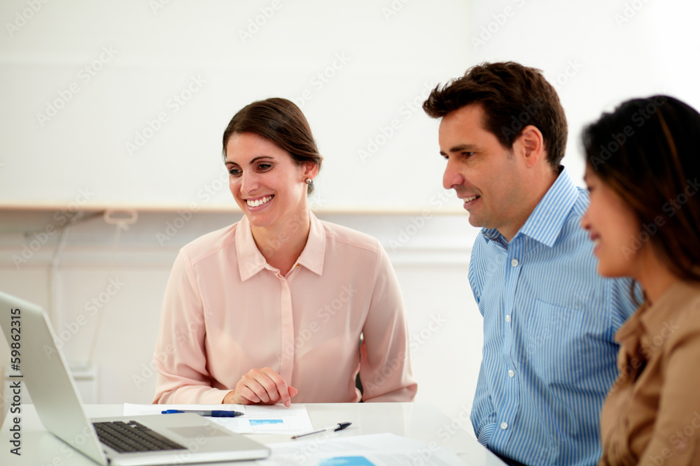 Adult professional colleagues looking at laptop Adult professional colleagues looking at laptop