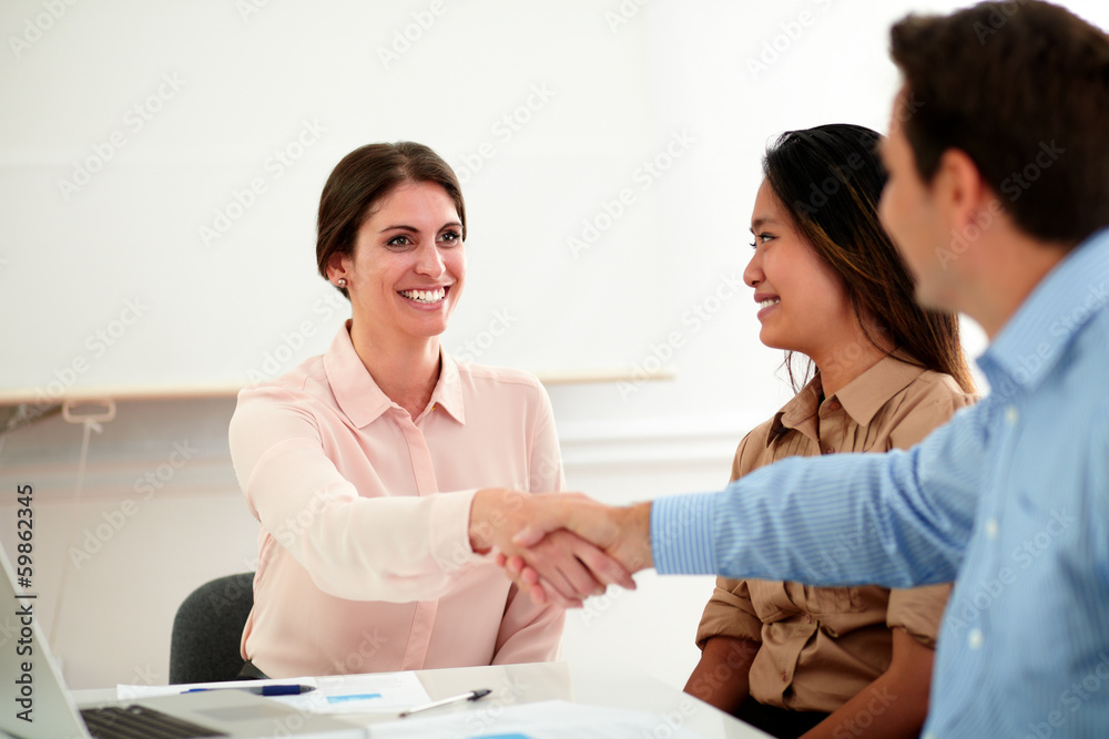 Young businesswoman giving greeting to businessman Young businesswoman giving greeting to businessman