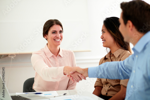 Young businesswoman giving greeting to businessman