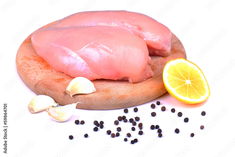 Chicken breasts on cutting board isolated on white Chicken breasts on cutting board isolated on white