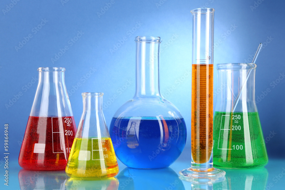 Test tubes with colorful liquids on blue background Test tubes with colorful liquids on blue background