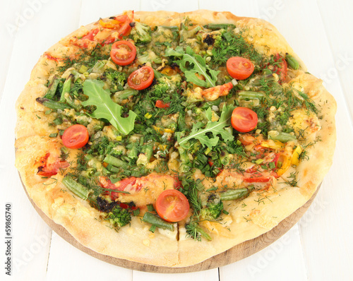 Tasty vegetarian pizza on wooden table