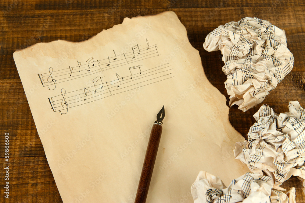 Fototapeta premium Crumpled paper balls with ink pen and music sheet