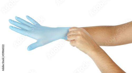 Doctor putting on protective gloves, isolated on white