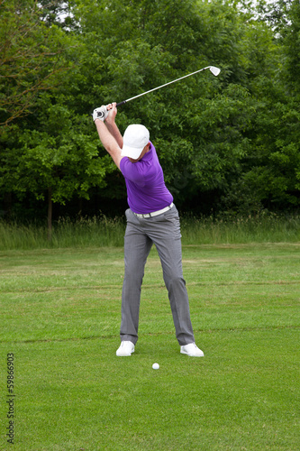Golfer playing a mid iron shot