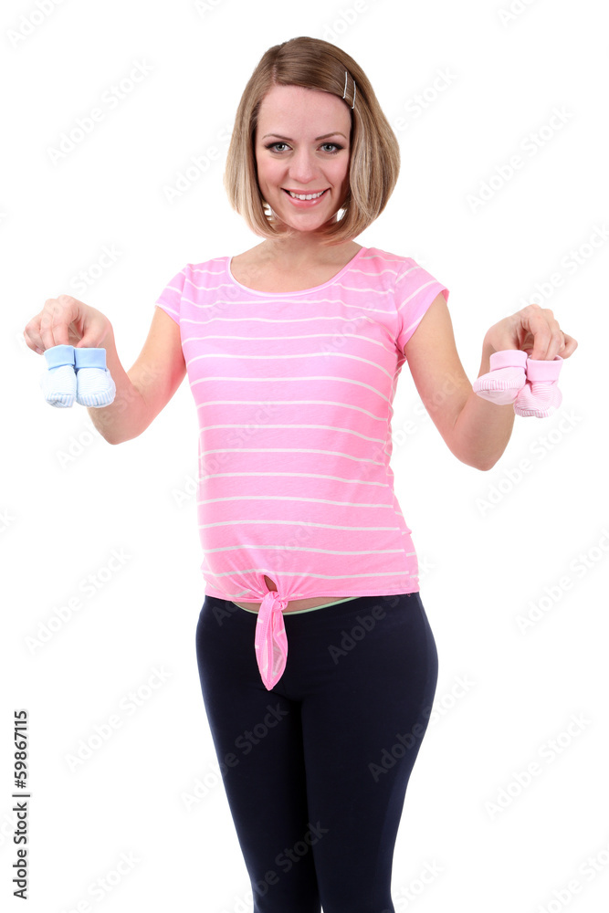 Young pregnant woman holding blue and pink baby shoes isolated Young pregnant woman holding blue and pink baby shoes isolated