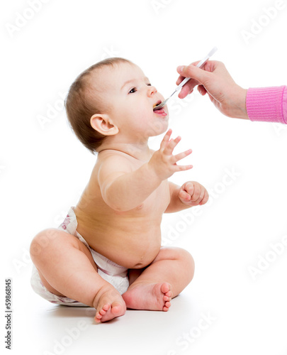 mother feeding baby  with a...
