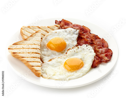 Fototapet Breakfast with fried eggs, bacon and toasts