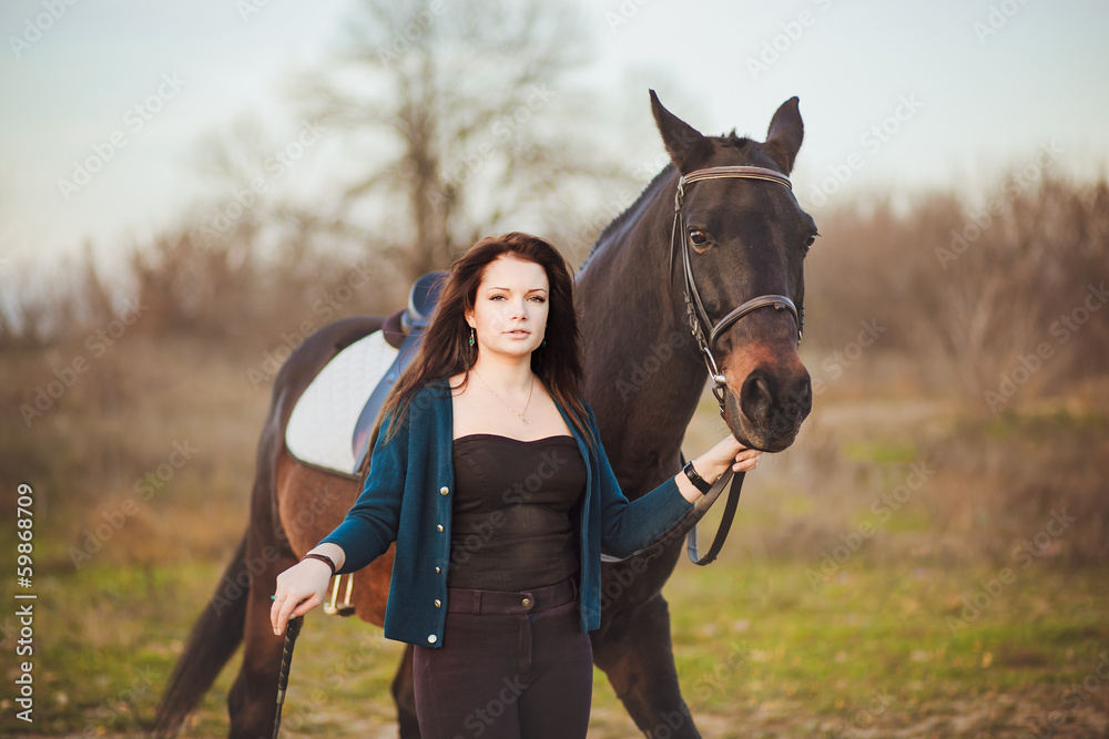 Obraz premium Young woman with a horse on nature