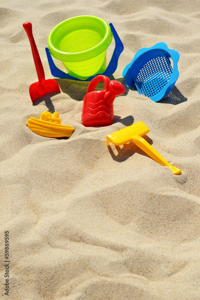 Plastic children toys on the sand beach Plastic children toys on the sand beach