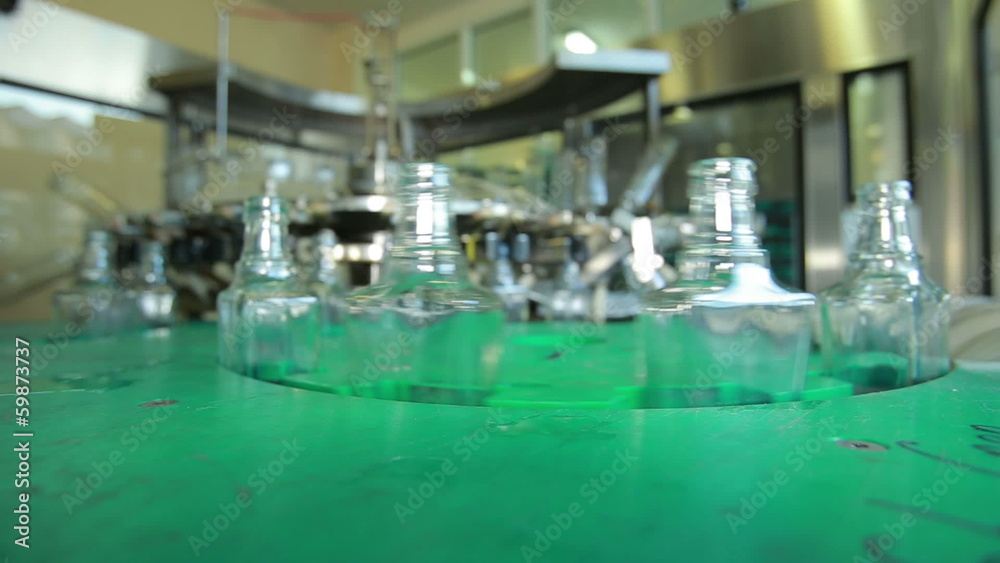 Empty Vodka Bottles Moving Along the Conveyor Line Empty Vodka Bottles Moving Along the Conveyor Line