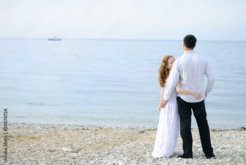 beautiful young couple in love near the sea