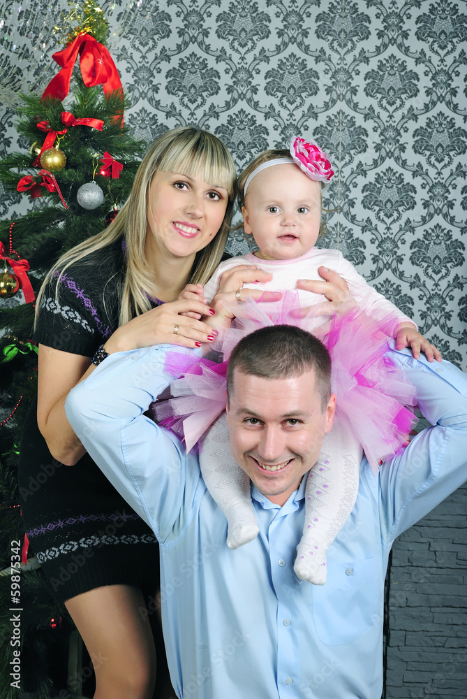 Small girl with parent near fir trees Small girl with parent near fir trees