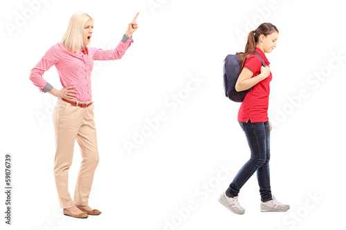 Full length portrait of angry mother yelling at her daughter