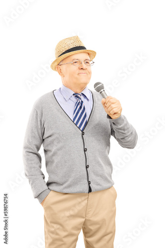 Happy senior man holding a microphone © Ljupco Smokovski