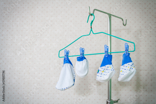 Hanged baby clothes on clothes hanger