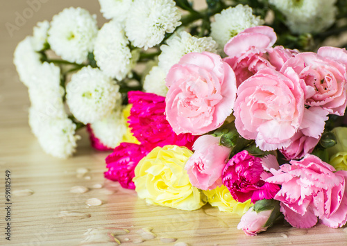 Carnations on wood background © ArtBackground