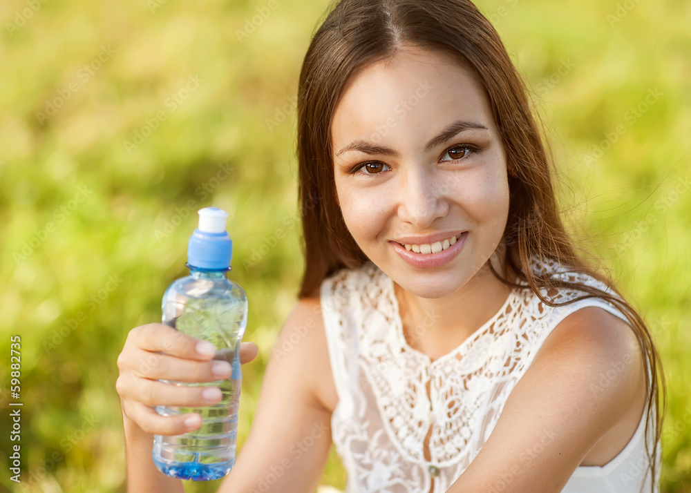 Portrait half face of young woman holding water bottle at summer Portrait half face of young woman holding water bottle at summer