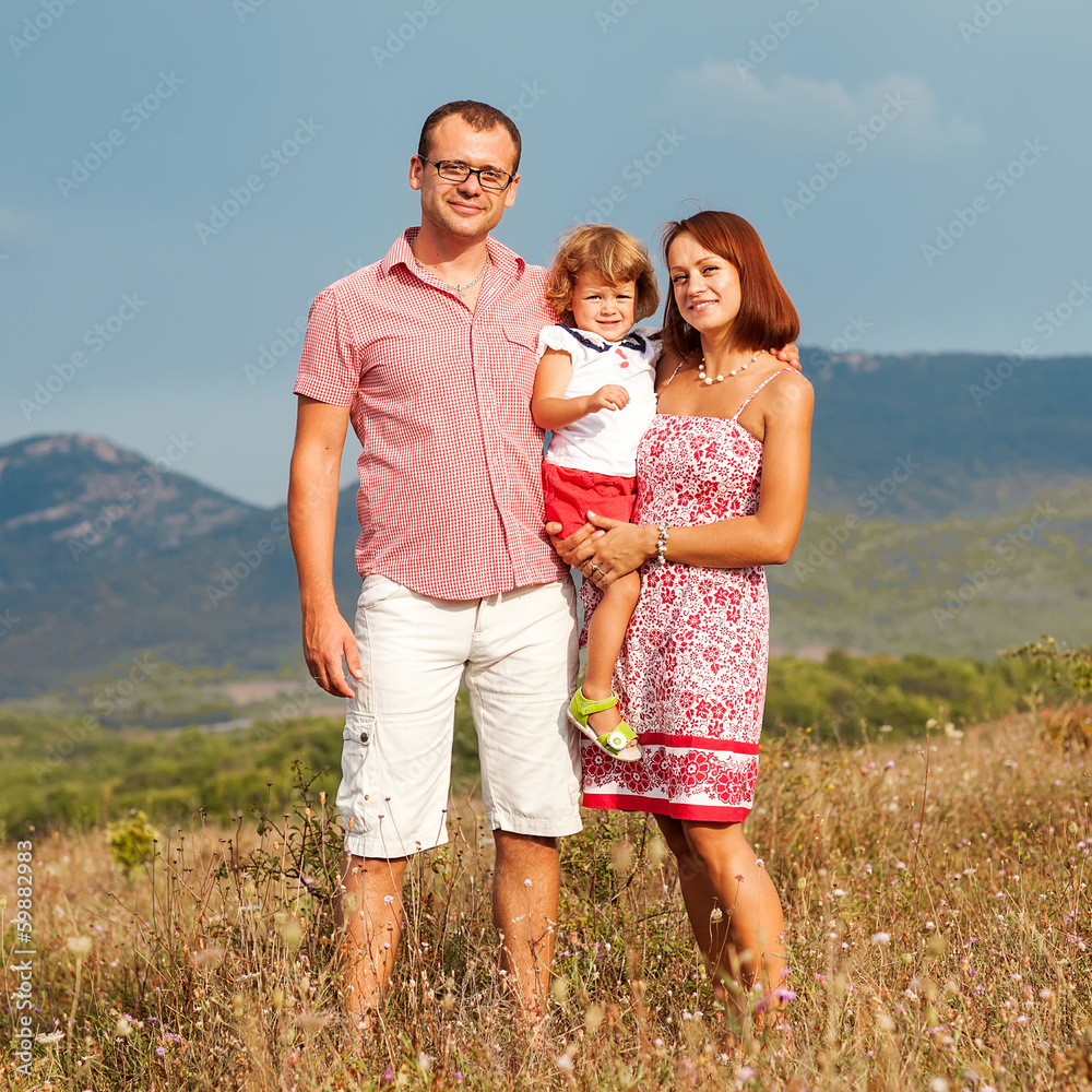 Happy mother, father and daughter in sunset Happy mother, father and daughter in sunset