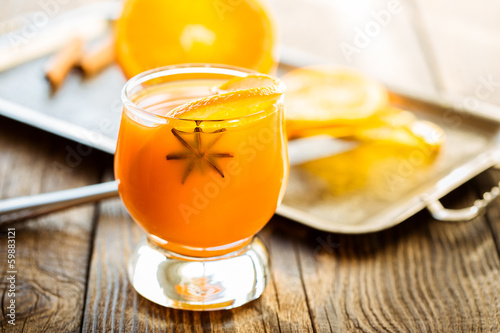 Fresh orange juice with orange slice and anise