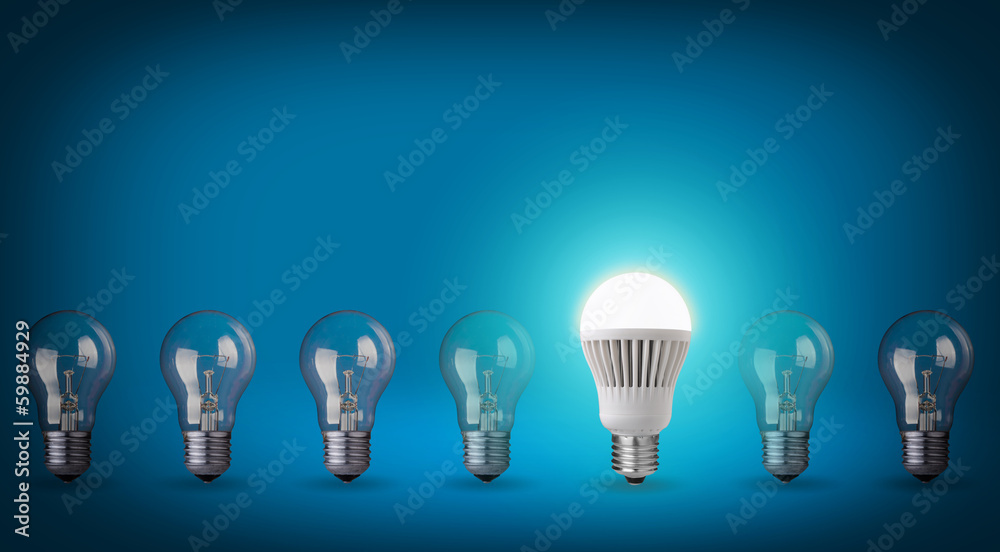 Idea concept on blue background. Row with light bulbs and LED bu Idea concept on blue background. Row with light bulbs and LED bu