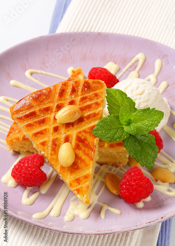 Almond cake with ice cream and raspberries photo