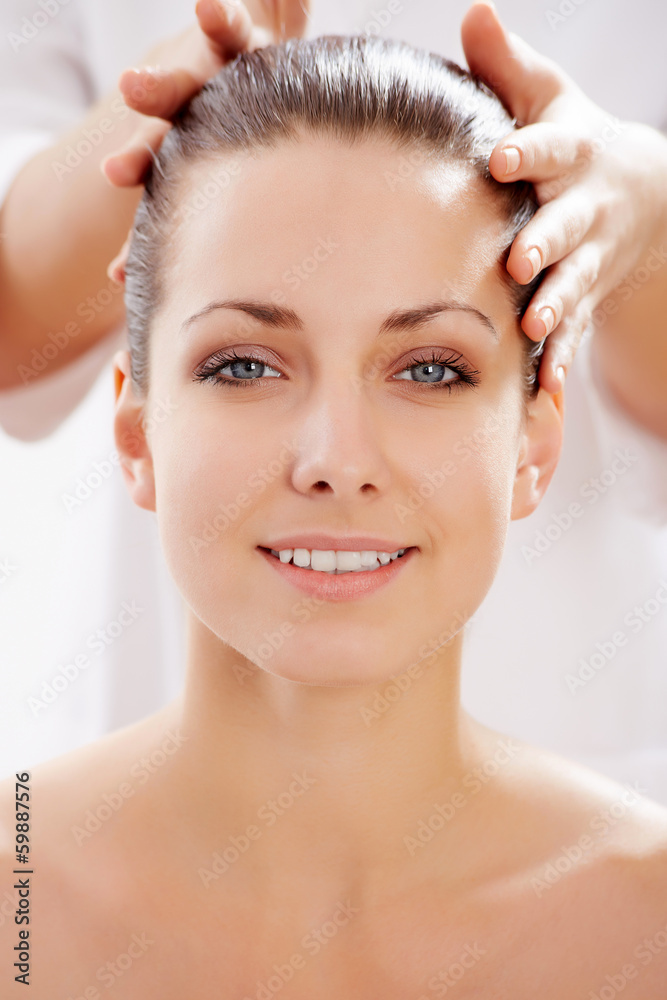 Naklejka premium Young beautiful woman in spa environment