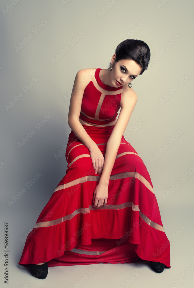 Pretty brunette woman in long evening expensive red dress Pretty brunette woman in long evening expensive red dress