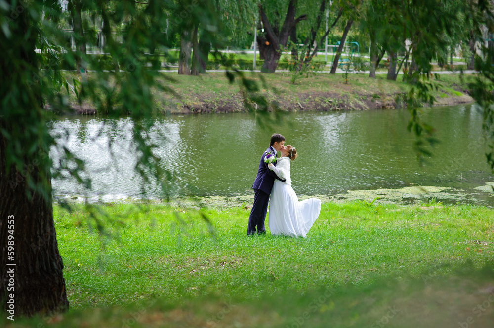 bride and groom in the park, a wedding bouquet, wedding dresses bride and groom in the park, a wedding bouquet, wedding dresses