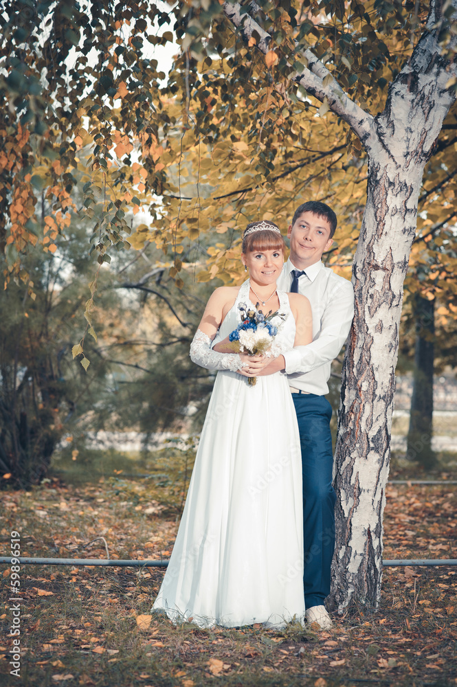 bride and groom in the park, a wedding bouquet, wedding dresses bride and groom in the park, a wedding bouquet, wedding dresses