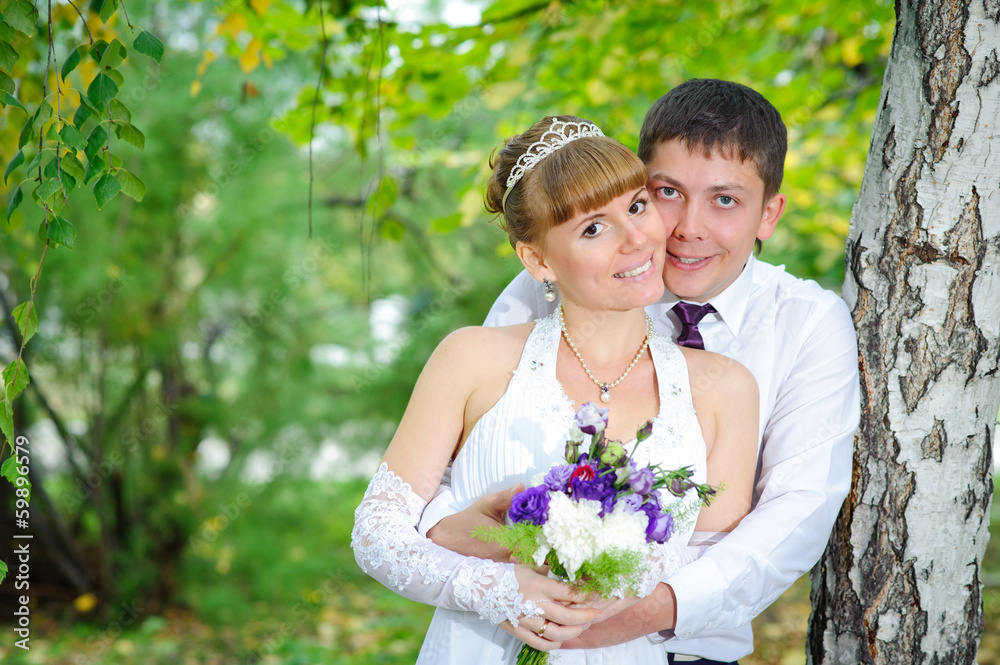 bride and groom in the park, a wedding bouquet, wedding dresses bride and groom in the park, a wedding bouquet, wedding dresses