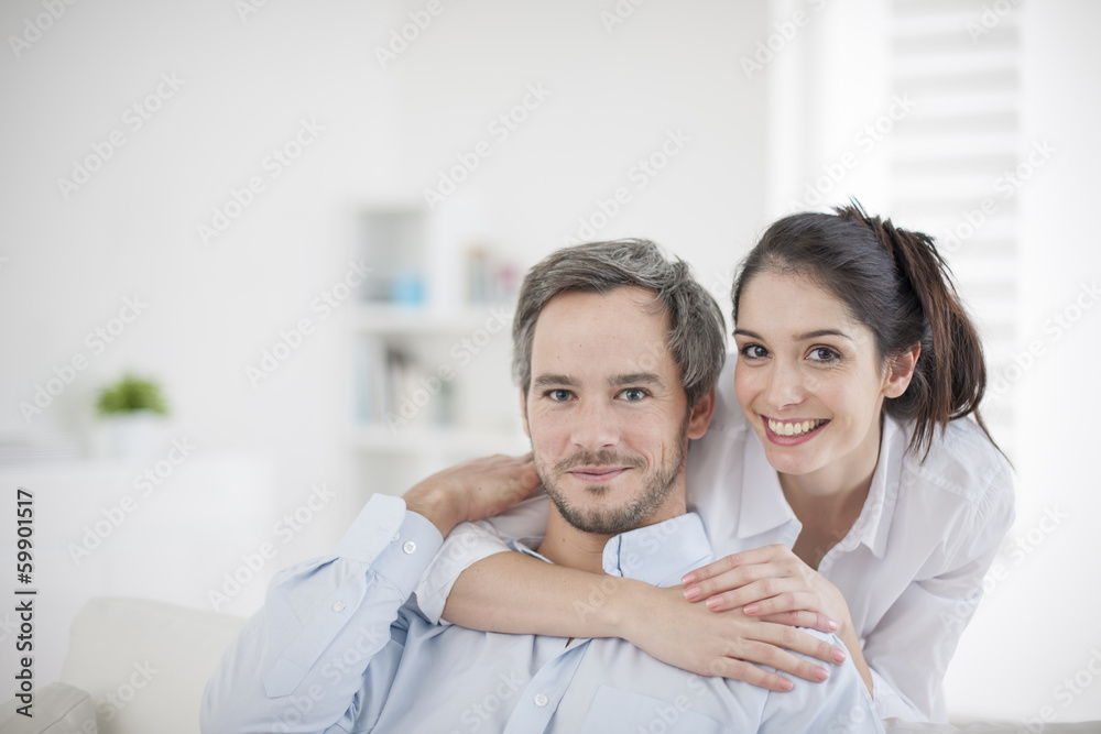 Obraz premium Couple at home relaxing in sofa