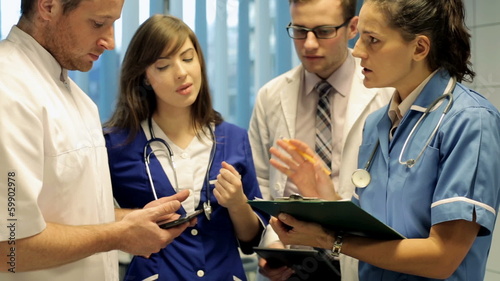 Young group of doctors discussing over documents