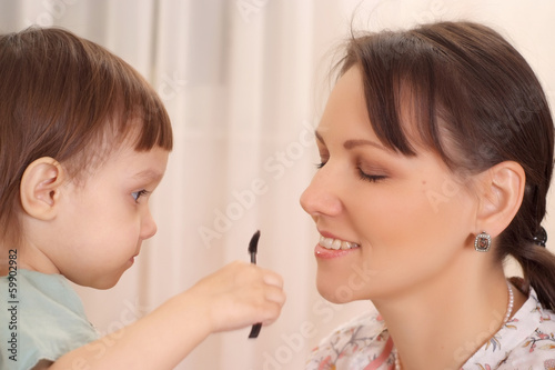 Daughter making up her mother